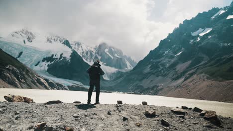 Rear-View-Of-Backpacker-Facing-Laguna-Torre-And-Cerro-Torre-In-Patagonia,-Argentina