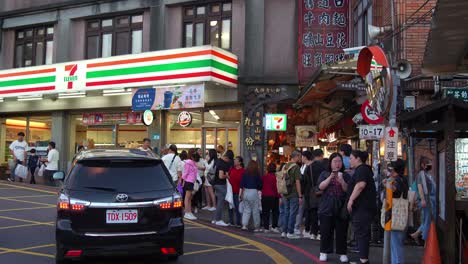 People-at-the-entrance-of-Jiufen-Old-Street,-a-gold-mining-mountain-town,-popular-tourist-attraction-in-Taiwan