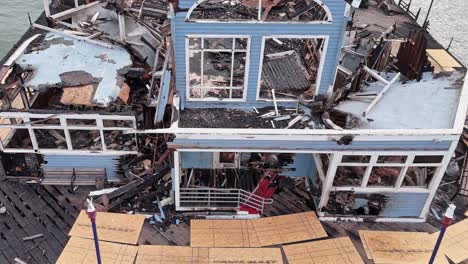 Oceanside-California-Pier-Fire-Damaged-Former-Rubys-Diner-Drone-Flyover-Rear-To-Front-Angle-Surveying-Debris