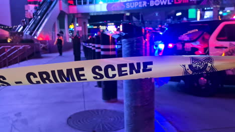 Las-Vegas-USA,-Crime-Scene-To-Not-Cross-Tape-on-Strip-Sidewalk-With-Police-Cars-and-Emergency-Lights-in-Background