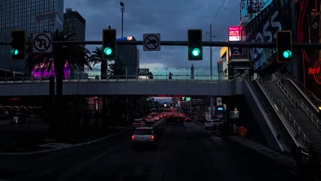 Las-Vegas-USA,-Driving-on-Vegas-Strip-in-Twilight,-Shiny-Buildings,-Cars-and-Lights