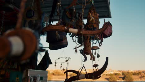 Stylized-souvenirs-hanging-under-the-ceiling-of-a-handmade-craft-store-in-Market-street-in-Nubian-Village,-Aswan,-Egypt