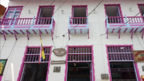 Charming-striped-balconies-on-a-colonial-building-in-Filandia,-Colombia