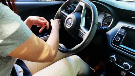Woman-Steering-Left-Behind-the-Wheel,-Close-Up-Slow-Motion
