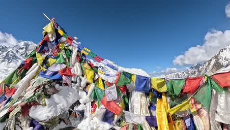 The-summit-of-lower-Kyanjin-Ri-adorned-with-colorful-Tibetan-prayer-flags,-symbolizing-peace-and-compassion-against-the-backdrop-of-the-majestic