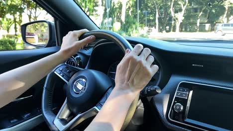 Person-Driving-with-Hand-on-Steering-Wheel-on-Road-Trip,-Slow-Motion,-Close-Up