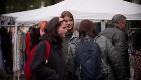 Young-festival-audience-visit-stalls-with-goodies-at-flea-market-Amsterdam