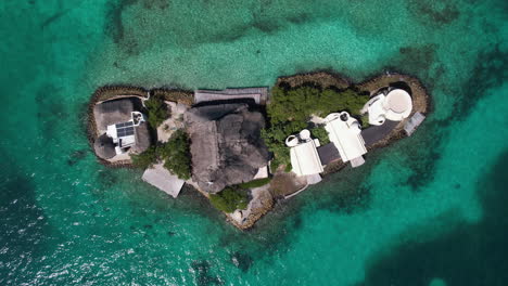 Top-Down-Aerial-View-of-Small-Island-in-Caribbean-Sea,-Buildings-and-Coast