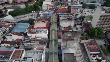 Aerial-View-Drone-Slow-Descend-into-Green-Roof-of-Petaling-Street-in-Chinatown-called-Green-Dragon