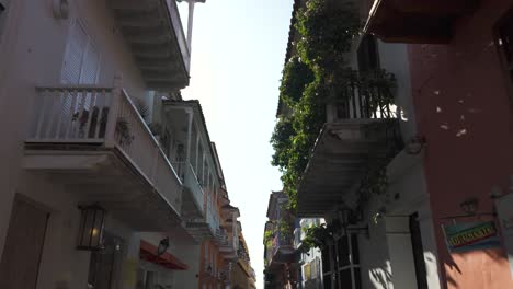 Dolly-between-shaded-building-alleyway-in-Cartagena-Colombia-at-midday