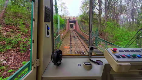 POV-inside-a-funicular-railway-driver's-control-cabin-climbing-uphill