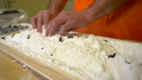 Make-typical-Dutch-sweets,-hopjes,-the-old-fashioned-way-by-pouring-syrup-into-molds-of-powdered-sugar