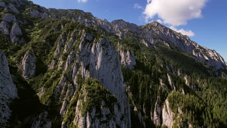 Majestic-Piatra-Craiului-mountain-range-under-a-clear-blue-sky,-aerial-view