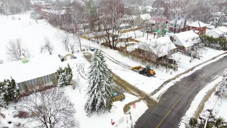 Loader-Plowing-Snow-To-Clear-The-Road-During-Blizzard-In-Longueuil,-Quebec,-Canada