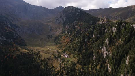 Autumn-colors-in-Bucegi-Mountains-with-a-secluded-chalet,-aerial-view