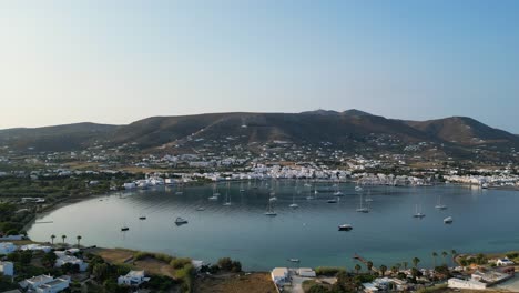 Aerial-footage-of-the-town-and-port-of-Parikia-on-the-island-of-Paros,-one-of-the-many-Cyclades-Islands-in-the-Aegean-Sea