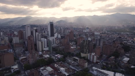 Sunset-hues-drape-over-Medellin's-skyline,-Colombia---aerial