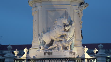 Lisbon,-Commerce-Square,-King-Jose's-Statue's-Base-Details-zooming-in-during-dusk
