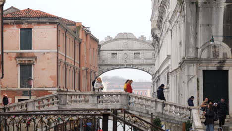 People-Walking-On-Ponte-della-Canonica-With-Bridge-Of-Sighs-In-Background