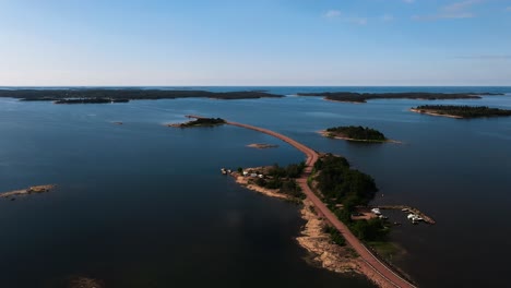 Aerial-view-rising-in-front-of-a-road,-connecting-islands-in-Vardo,-Aland,-Finland
