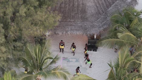 Aerial-view-overlooking-colourful-athletic-dancers-performance-on-Michamvi-Kae-beach-in-Zanzibar