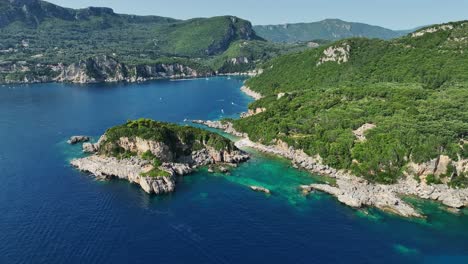 Limni-beach-glyko-on-corfu-island,-sunlit-coast-with-clear-turquoise-ionic-sea-waters,-aerial-view