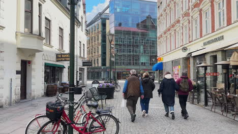 People-Walking-On-Skomakaregatan-Street-In-Malmo,-Sweden