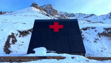 Red-cross-hospital-emergencies-sign-in-wood-house