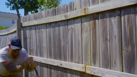 Contractor-uses-prybar-during-fence-repair.-Medium-Shot