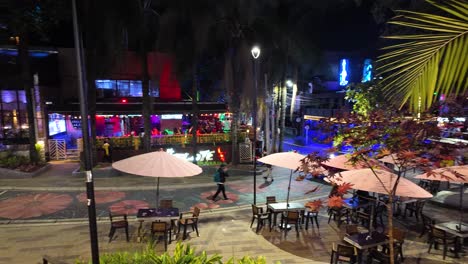 Vibrant-nightlife-scene-in-El-Poblado,-Medellin,-with-colorful-lights-and-outdoor-dining