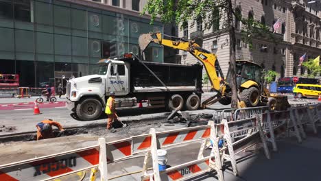 A-street-view-of-men-digging-a-trench-along-Fifth-Avenue-in-NYC-on-a-sunny-day