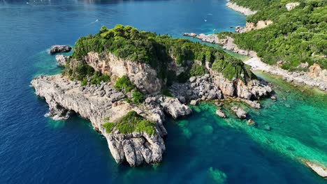 Limni-beach-glyko-on-corfu-island,-lush-greenery-atop-rugged-cliffs-against-the-ionic-sea,-aerial-view