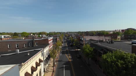 Aerial-establishing-flight-over-Main-Street-of-small-american-town-at-sunset-time