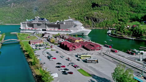 Luxury-cruise-ship-at-the-port-of-Flam,-Norway---aerial