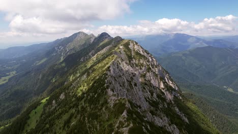 The-sunlit-piatra-craiului-mountains-with-lush-greenery-and-rolling-peaks,-aerial-view