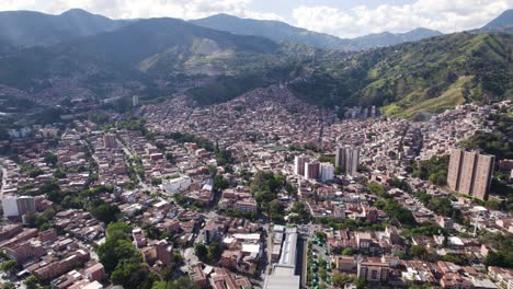 Sweeping-aerial-view-of-Comuna-13-nestled-in-Medellin's-valley,-Colombia