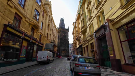 European-cobbled-city-street-leading-to-a-medieval-gothic-dark-tower