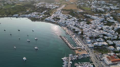 Aerial-footage-of-the-town-and-port-of-Parikia-on-the-island-of-Paros,-one-of-the-many-Cyclades-Islands-in-the-Aegean-Sea