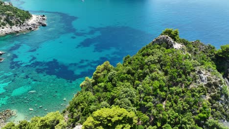 Üppige-Grüne-Klippen-Auf-Der-Insel-Korfu-Mit-Kristallblauem-Wasser-Des-Ionischen-Meeres,-Luftaufnahme