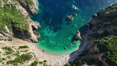 Giali-beach-in-corfu-with-clear-blue-waters-and-sandy-shore,-greece,-aerial-view