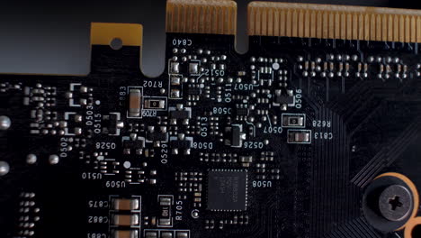 Close-up-of-an-SLI-interface-on-the-back-of-a-graphics-card,-detailing-the-circuitry-and-PCB-layout,-tech-focused