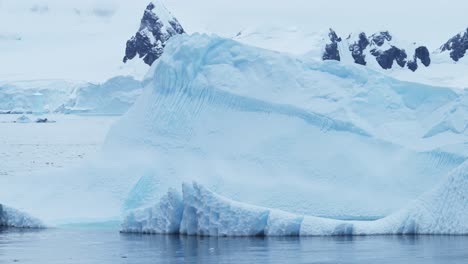 Big-Massive-Iceberg-Floating-in-Ocean,-Beautiful-Dramatic-Antarctica-Ice-Landscape-in-Blue-Coastal-Scene-on-Antarctic-Peninsula-Coast,-Icy-Winter-Sea-Scene