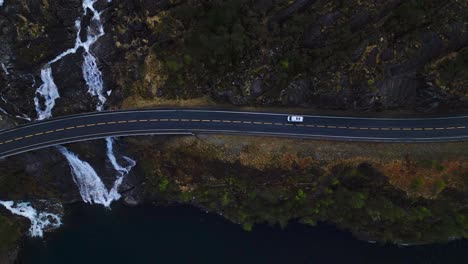 Minivan-drove-through-bridge-beside-a-Langfossen-Waterfall,-Norway