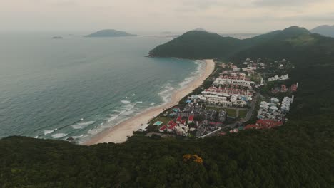 Aerial-view-revealing-Brava-Beach-in-Florianopolis-during-a-cloudy-sunset