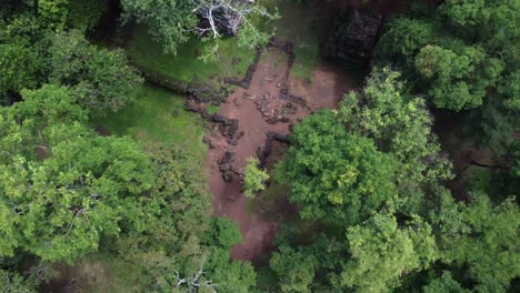 Jungle-aerial-rises-over-ancient-stonework-at-overgrown-Koh-Ker-Temple