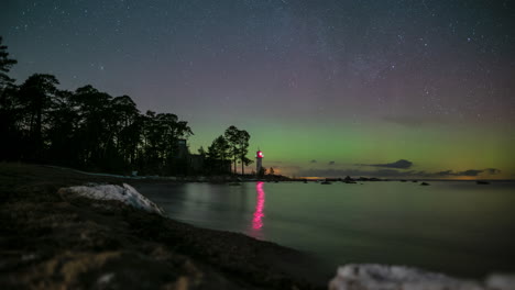 Northern-lights-dance-across-night-sky-by-light-house-on-shore-of-Vergi-Estonia