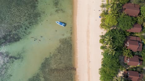 Slow-motion-drone-flight-over-stunning-beach-resort-next-to-ocean