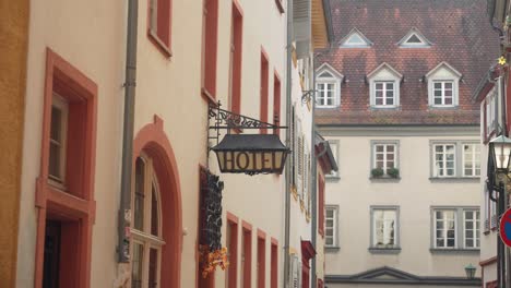 Old-vintage-hanging-Hotel-sign-in-historic-city-Heidelberg,-Germany
