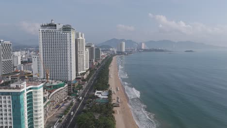 An-enchanting-drone's-eye-view-of-Nha-Trang-cityscape,-where-clouds-dance-above-the-picturesque-skyline,-accentuating-its-natural-beauty