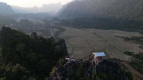 drone-shot-of-hikers-hut-and-airplane-on-cliff-in-Vang-Vieng,-the-adventure-capital-of-Laos